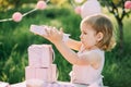 Happy birthday little girl with pink decor in beautiful garden. Royalty Free Stock Photo