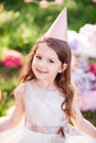 Happy birthday little girl with pink decor in beautiful garden Royalty Free Stock Photo