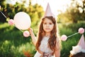 Happy birthday little girl with pink decor in beautiful garden. Royalty Free Stock Photo