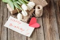 Happy birthday mesage with flowers on rustic table with flowers Royalty Free Stock Photo