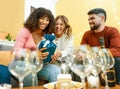 Happy birthday moment with multiracial real people at home laughing celebrating with champagne, cake with candle light effect. Royalty Free Stock Photo