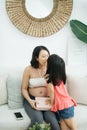 Happy Birthday, Mommy. Happy Pregnant Woman Receiving Gift Box From Her Loving Little Daughter Royalty Free Stock Photo