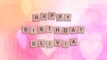 Happy Birthday Olivia card with wooden tiles text Royalty Free Stock Photo