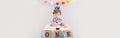 Happy birthday party. Cute Caucasian baby boy in blue crown celebrating first birthday at home. Child toddler in a high chair Royalty Free Stock Photo