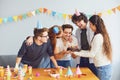 Happy Birthday party. A group of friends with a cake wishes the man a happy birthday Royalty Free Stock Photo