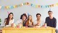 Happy Birthday party. A group of friends with a cake wishes the girl a happy birthday Royalty Free Stock Photo