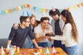 Happy Birthday party. A group of friends with a cake wishes the man a happy birthday Royalty Free Stock Photo