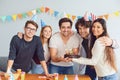 Happy Birthday party. A group of friends with a cake wishes the man a happy birthday Royalty Free Stock Photo