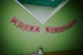 HAPPY BIRTHDAY  pink bunting paper banner hanging from a wall Royalty Free Stock Photo