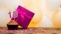 Happy birthday with pink gift box for 18 year old girl. Beautiful birthday card with a cupcake and a burning candle number Royalty Free Stock Photo