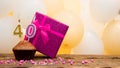 Happy birthday with pink gift box for 40 year old woman. Beautiful birthday card with cupcake and number forty burning candle Royalty Free Stock Photo