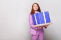 Happy birthday! Red haired cute girl holding her gifts and have Royalty Free Stock Photo