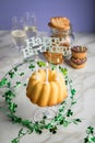 Happy birthday ring cake, cookies, biscuits, muffins and champagne  with clover decoration on marble table and lilac background Royalty Free Stock Photo