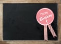 Happy Birthday rosette on a vintage slate