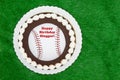 Happy Birthday Slugger baseball cake on a green fake grass