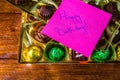 Happy birthday text on memo post reminder, near a golden box with chocolate pralines Royalty Free Stock Photo