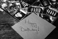 Happy birthday text on memo post reminder, near a golden box with chocolate pralines Royalty Free Stock Photo