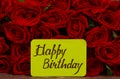 Happy Birthday text with Red roses in a bunch as a background. Royalty Free Stock Photo