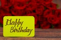 Happy Birthday text with Red roses in a bunch as a background. Royalty Free Stock Photo