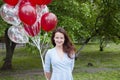 Happy birthday to me! happy woman with party birthday baloons outdoor in summer.