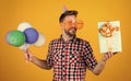 happy birthday to you. male holiday celebration. bearded guy with party balloons and gift box. unshaven handsome man Royalty Free Stock Photo