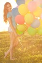 Happy birthday woman against the sky with rainbow-colored air balloons Royalty Free Stock Photo