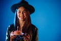 Happy birthday woman making wish - blowing candle on cake. Royalty Free Stock Photo