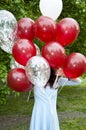 Happy birthday. happy woman with party birthday baloons outdoor in summer. hiding