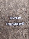 Happy birthday words written in sand at the beach Royalty Free Stock Photo