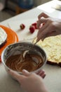 Happy birthday. A young woman is preparing cream for a cake. Festive cake decoration. Royalty Free Stock Photo