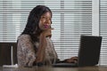 Happy black afro American business woman working cheerful with laptop computer by business district window desk in corporate Royalty Free Stock Photo