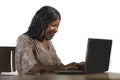 Happy black afro American business woman working cheerful with laptop computer by business district window desk in corporate Royalty Free Stock Photo