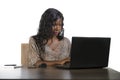 Happy black afro American business woman working cheerful with laptop computer by business district window desk in corporate Royalty Free Stock Photo