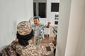 Happy black boy meets mother at home after army Royalty Free Stock Photo