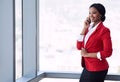 Happy black businesswoman smiling while talking on her mobile cellphone Royalty Free Stock Photo