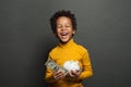 Happy black child boy with us dollar and money box Royalty Free Stock Photo