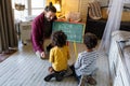 Happy children learning maths with father, teacher at home. Family education happiness concept