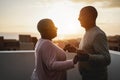 Happy black couple dancing outdoors at summer sunset - Focus on man face Royalty Free Stock Photo