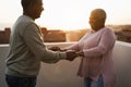 Happy black couple dancing outdoors at summer sunset - Focus on woman face Royalty Free Stock Photo