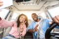 Happy black couple driving car and taking selfie Royalty Free Stock Photo