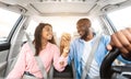Happy black couple enjoying drive on car, holding hands Royalty Free Stock Photo