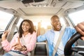Happy black couple enjoying music driving luxury car Royalty Free Stock Photo