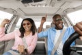 Happy black couple enjoying music driving luxury car Royalty Free Stock Photo