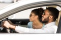 Happy black couple enjoying road trip, sitting in car Royalty Free Stock Photo