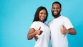Happy black couple gesturing thumbs up, hugging and smiling, banner Royalty Free Stock Photo