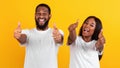 Happy black couple gesturing thumbs up and smiling, banner Royalty Free Stock Photo