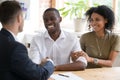 Happy black couple handshaking realtor insurer landlord at meeting Royalty Free Stock Photo