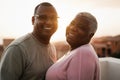 Happy black couple having tender moment outdoors at summer sunset - Soft focus on man face Royalty Free Stock Photo