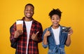 Happy Black Couple Holding Camera And Travel Tickets, Yellow Background Royalty Free Stock Photo