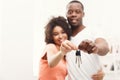 Happy black couple holding keys of their new home Royalty Free Stock Photo